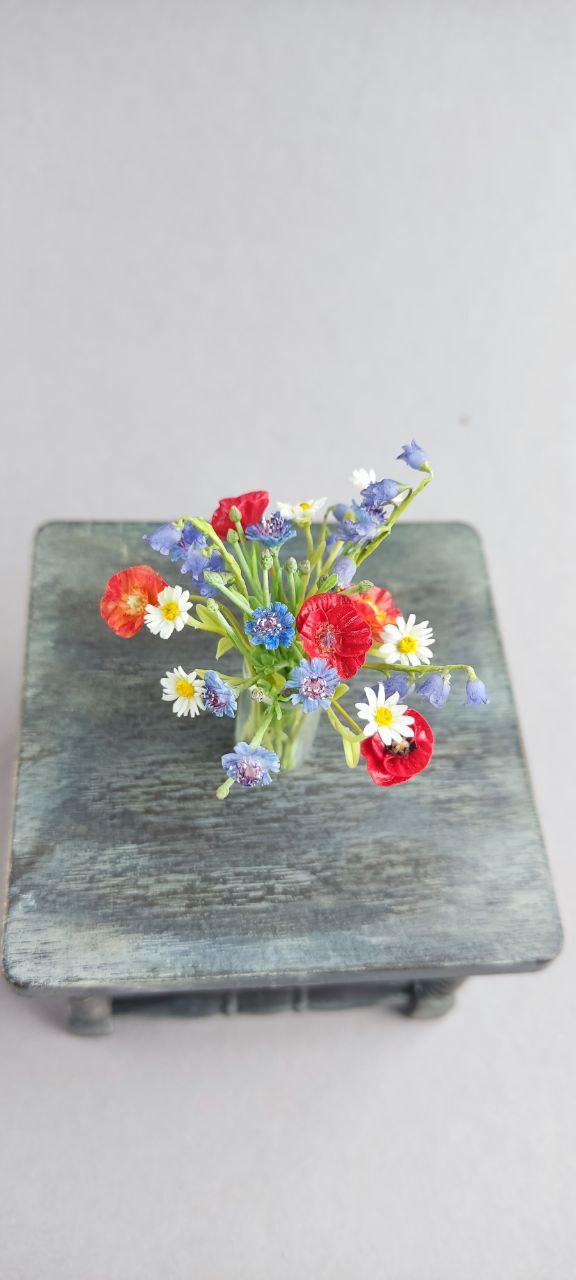 Field bouquet of daisies, poppies, bells and cornflowers.